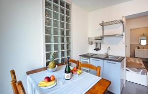 una cucina con tavolo, frutta e bottiglia di vino di Stunning Apartment In Chioggia With Wifi a Chioggia