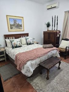 a bedroom with a large bed and a table at Ilnika Farm Stay in Naboomspruit +83 photos