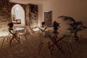a dining room with two tables and chairs with plants at Ferentino B&B in Ferentino