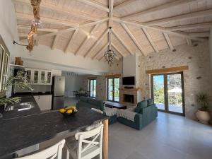 a kitchen and living room with a counter top in a room at SeaForest Villa, Grand New! 2 km from Beach in Corfu