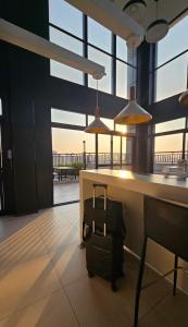 a bag of luggage sitting next to a bar with windows at Studio espaço Bom Retiro in Sao Paulo +35 photos