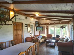 a living room with a couch and a table at Cicha Kolonia Krupicka in Krupice