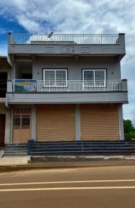 a building with a balcony on the side of it at AVANI Stays in Yelagiri