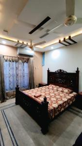 a bedroom with a large bed in a room at Star Guest House in Jhelum
