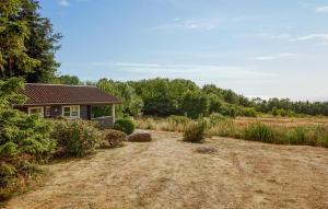 a house in a field next to a forest at Awesome Home In Hasle With House Sea View in Vysteby +5 photos