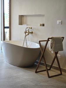 a large tub in a bathroom with a mirror at Porta di Savoca in Savoca