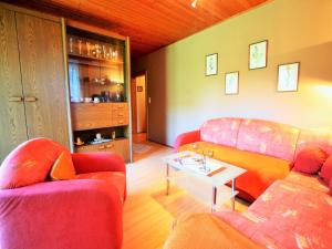 a living room with two couches and a table at Apartment in Liebetig near Gerlitzen Ski Area in Feldkirchen in Kärnten