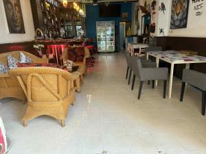 a store with chairs and tables in a room at Flowernight Guesthouse in Kata Beach