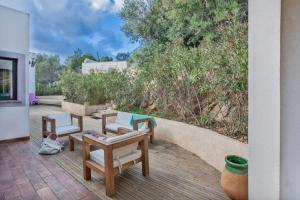 a patio with a bunch of chairs and a table at Villa Annonciade in LʼÎle-Rousse