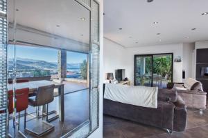 a living room with a couch and a table at Villa Annonciade in LʼÎle-Rousse