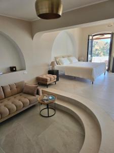 a bedroom with a bed and a couch and a table at Porta di Savoca in Savoca