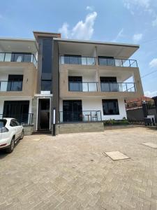 a building with a car parked in front of it at Ikamba-Lakeview Apartment in Kampala
