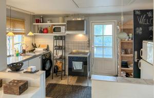 a kitchen with a sink and a stove top oven at 2 Bedroom Cozy Home In Hasle in Vysteby