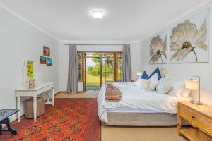 a bedroom with a bed and a table and a desk at Wellstead Cathkin Park in Cathkin Park