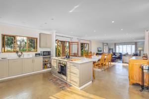 a kitchen and living room with a table and chairs at Wellstead Cathkin Park in Cathkin Park