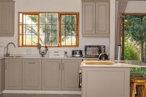 a kitchen with white cabinets and a chicken on the counter at Wellstead Cathkin Park in Cathkin Park +43 photos
