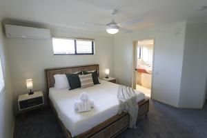 Un dormitorio con una cama con dos toallas encima. en Bayside Bliss 8 Sleeper Family Escape, en Deception Bay