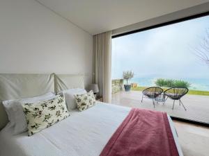 a bedroom with a bed and a large window at NEW!! Lugar das Letras in Sabrosa +92 photos