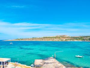 a view of a large body of water at Sunny Beach House with Jacuzzi - Steps from the Sea in St Paul's Bay