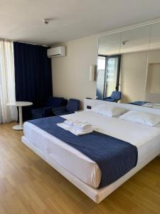 a hotel room with a large bed with a mirror at Orbi City Premium Sea View Apartments in Batumi