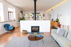 a living room with a couch and a fireplace at Spacious Villa with Private Pool & Garden in Douro, by Hopstays in Sabrosa