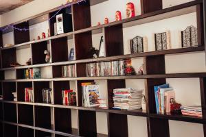 a book shelf filled with books and dvds at The Title by Eeri in Rawai Beach