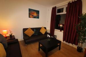 a living room with a couch and a table at Reeves House By Smart Corporate Stays in Derby +51 photos