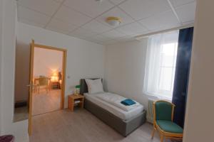a small room with a bed and a mirror at Room4You - Bad Hersfeld in Bad Hersfeld
