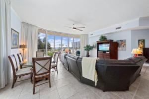 a living room with a couch and a table and chairs at The Moorings 101 in Caswell +32 photos