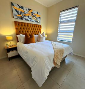 a bedroom with a large bed and a window at Elite Executive Suite Midrand in Midrand