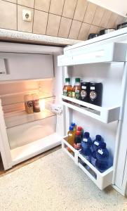 an open refrigerator filled with lots of food at Cozy City Apartments 2, 2-Room Flat for Vacation & Messe Düsseldorf, Perfect Connectivity in Ratingen