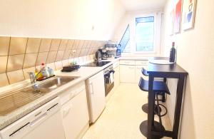 a small kitchen with a sink and a counter at Cozy City Apartments 2, 2-Room Flat for Vacation & Messe Düsseldorf, Perfect Connectivity in Ratingen