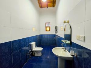 a blue and white bathroom with a toilet and a sink at Calm Villa in Ahangama +43 photos
