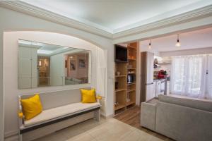 a living room with a couch and yellow pillows at Lucamare - Casa Rossa in LʼÎle-Rousse