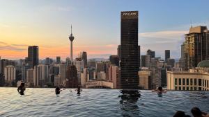 a infinity pool with a view of the city at Axon Residence Pavilion Bukit Bintang SkyView in Kuala Lumpur