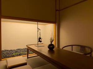 a room with a table with a vase on it at 玄Gen Private Villa in Takayama