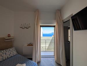a bedroom with a bed and a view of the ocean at BELVEDERE apartment in Scilla