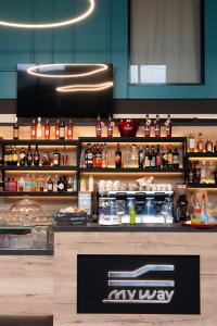 a restaurant with a counter with food and drinks at SELF CHECK IN Arbed Living Apartments Arbedo Castione in Arbedo-Castione