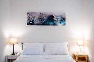 a bedroom with a white bed and two lamps at Firenze Center - 5min to Duomo, Station - Wifi and AC in Florence