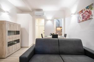 a living room with a couch and a table at Firenze Center - 5min to Duomo, Station - Wifi and AC in Florence