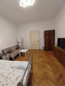 a living room with a bed and a couch at CENTRAL 2 ZAGREB in Zagreb