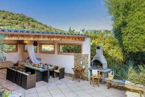 een patio met een tafel en een open haard bij Villa A Surgenta in Monticello