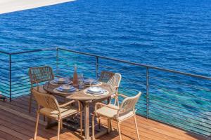 einen Tisch und Stühle auf dem Deck eines Kreuzfahrtschiffes in der Unterkunft Casa Bordimare Miomo Cap Corse in La Vasina