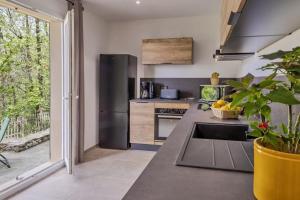 a kitchen with a stainless steel refrigerator and a sink at Casa U Castagnettu 2 in Patrimonio