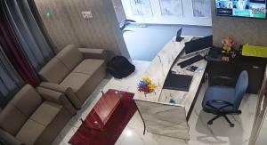 an overhead view of a living room with a couch and a desk at Hotel Silver Fountain Ranchi in Rānchī