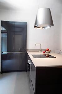 a kitchen with a sink and a glass shower at Solferino Suite in Milan