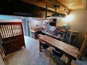a kitchen with a wooden table and a counter top at 雜院-晴海 新北市民宿證號333號 in Jiufen