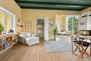 a living room with a couch and a table at Historic House Near Råbjerg Mile And North Sea in Kandestederne