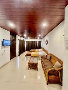 a living room with two beds and a couch at Vortex homes in Guwahati