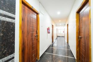 a corridor with two doors and a hallway with a floor at Hotel O Shamshabad in Hyderabad